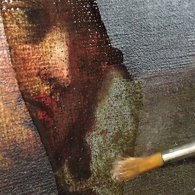 closeup photo of a paint brush cleaning a painting